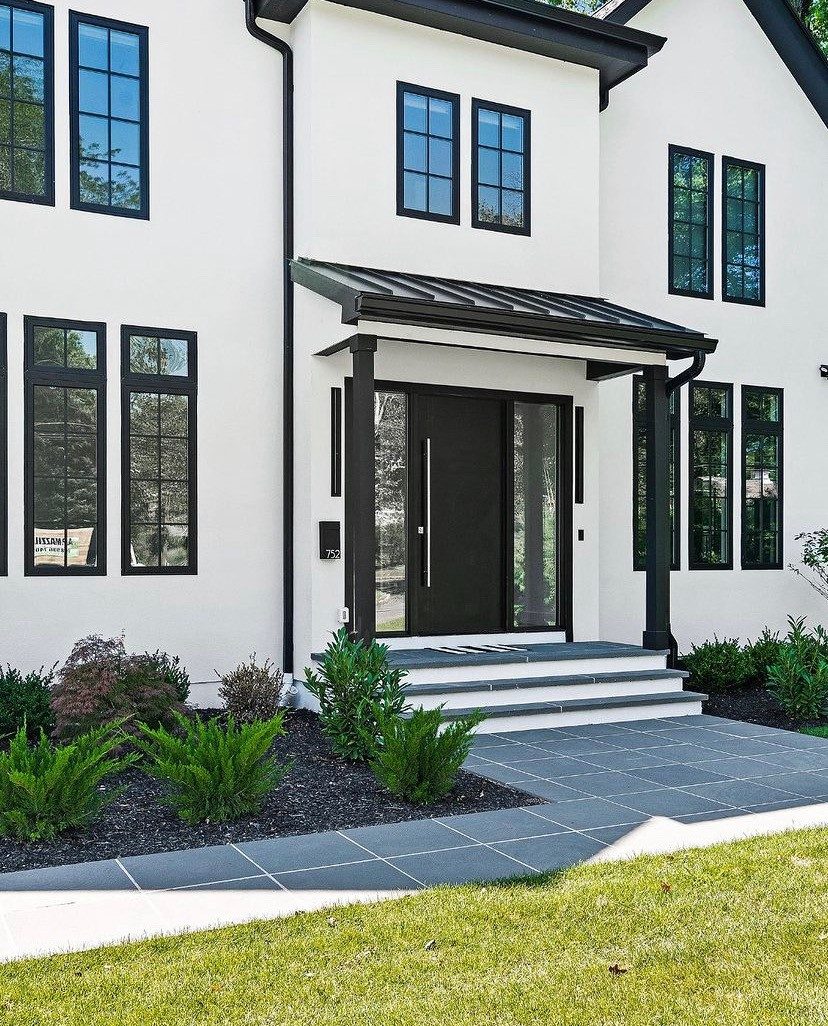 Modern black entry door on a white stucco home