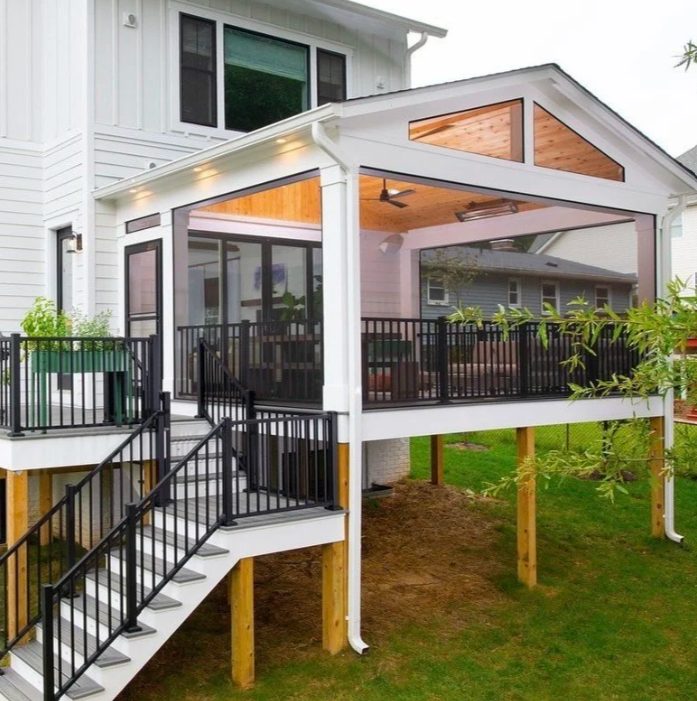 Screened porch with black railing and wood ceiling