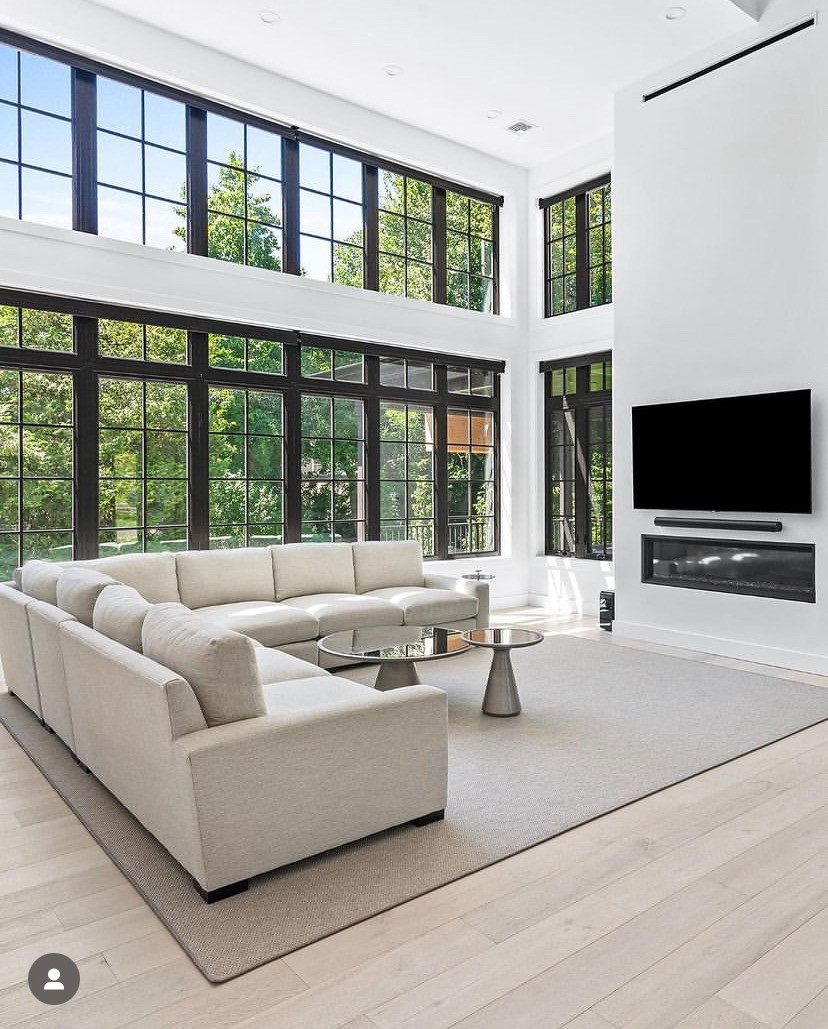 Great room interior with two stories of black frame windows